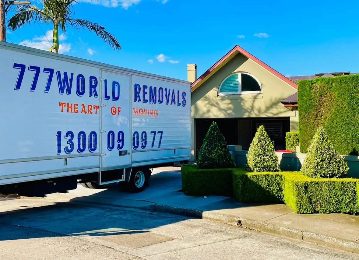 Furniture removalists Wollongong: 777 World Removals truck outside a family home