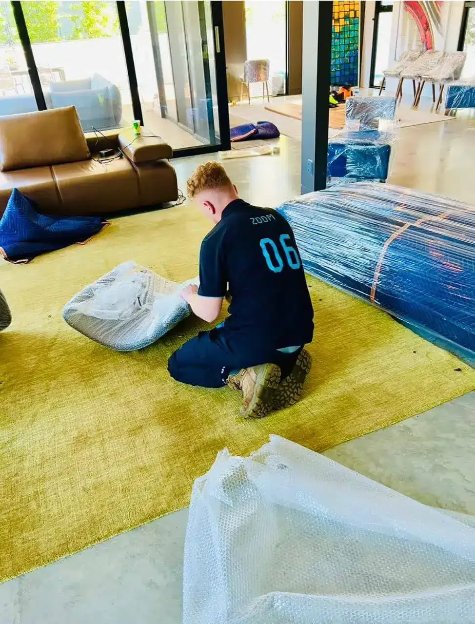 777 World Removals removalist wrapping furniture on the job in Wollongong